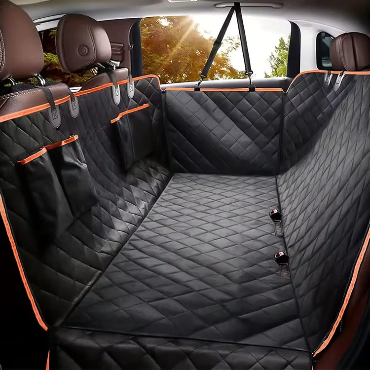 ROAMTAIL black dog car hammock installed across a car back seat.